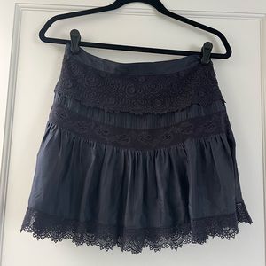 Black LoveShackFancy mini skirt with lace detailing